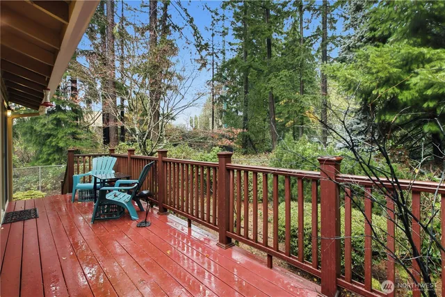 a balcony with wooden floor and outdoor seating
