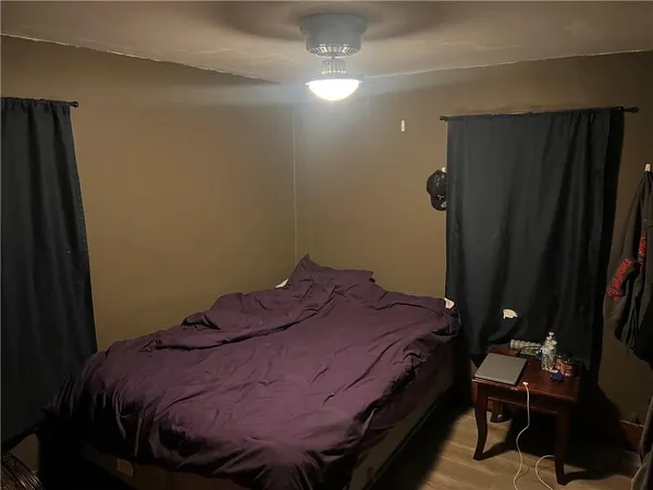 a bed sitting in a bedroom next to a bathroom