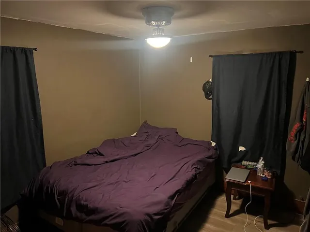 a bed sitting in a bedroom next to a bathroom