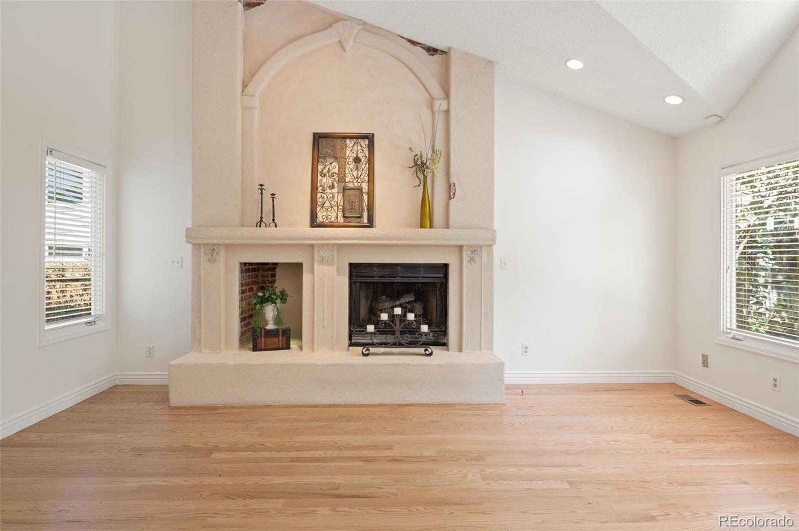 9368 Harvard Drive Highlands Ranch, CO 80130 - Photo 19 of 46 a view of an empty room with a window and fireplace