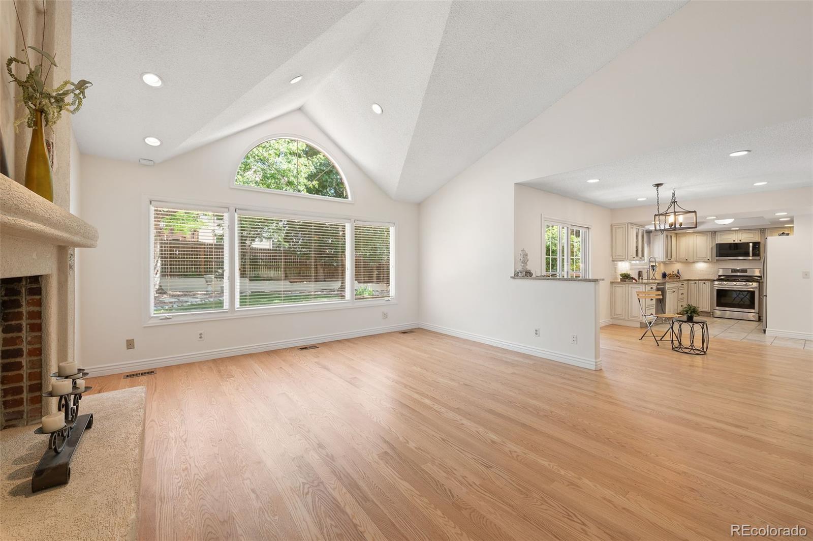 9368 Harvard Drive Highlands Ranch, CO 80130 - Photo 20 of 46 a view of an empty room with a window and wooden floor