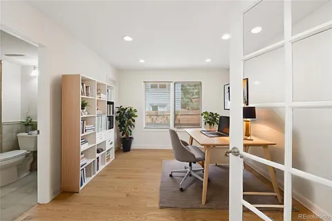 a view of a workspace with furniture and a window