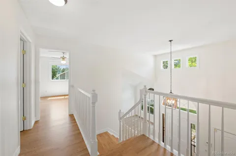 a view of hallway with wooden floor