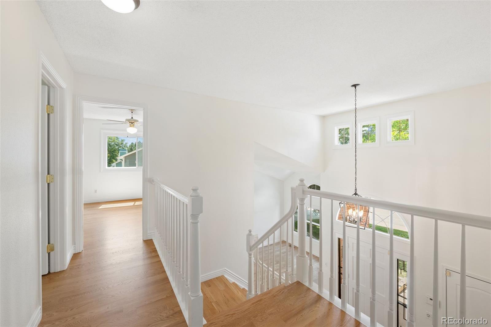 9368 Harvard Drive Highlands Ranch, CO 80130 - Photo 23 of 46 a view of hallway with wooden floor