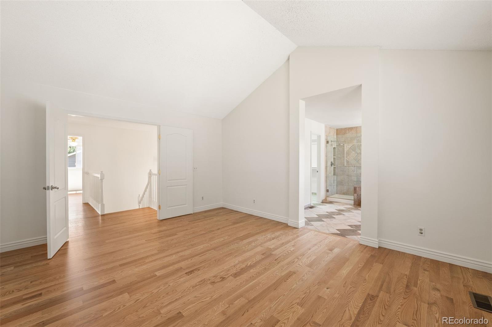 9368 Harvard Drive Highlands Ranch, CO 80130 - Photo 25 of 46 a view of an empty room with wooden floor and a window