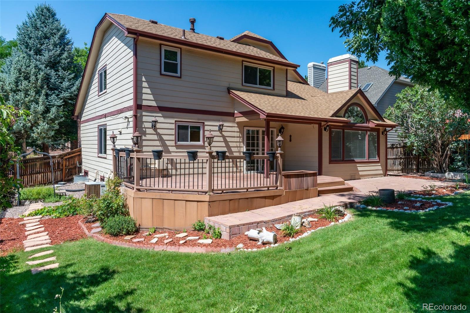 9368 Harvard Drive Highlands Ranch, CO 80130 - Photo 37 of 46 a front view of house with yard and outdoor seating