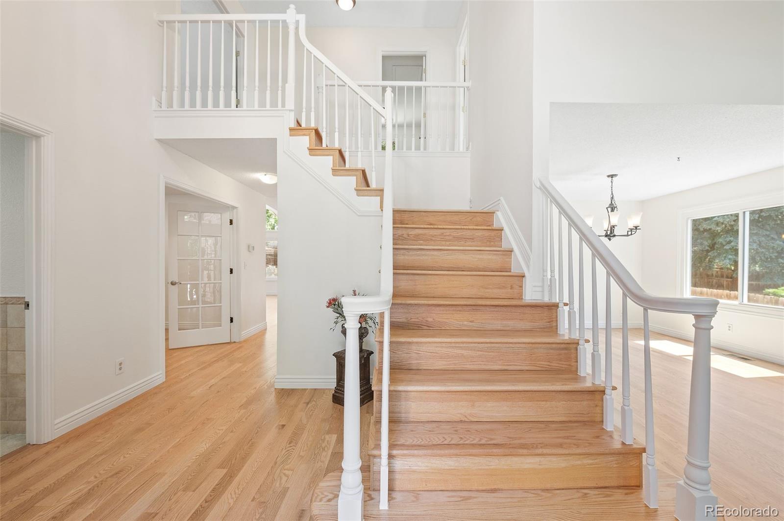 9368 Harvard Drive Highlands Ranch, CO 80130 - Photo 5 of 46 a view of entryway and hall with wooden floor