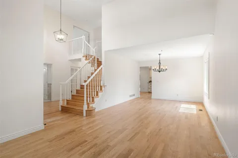 a view of a room with wooden floor and stairs