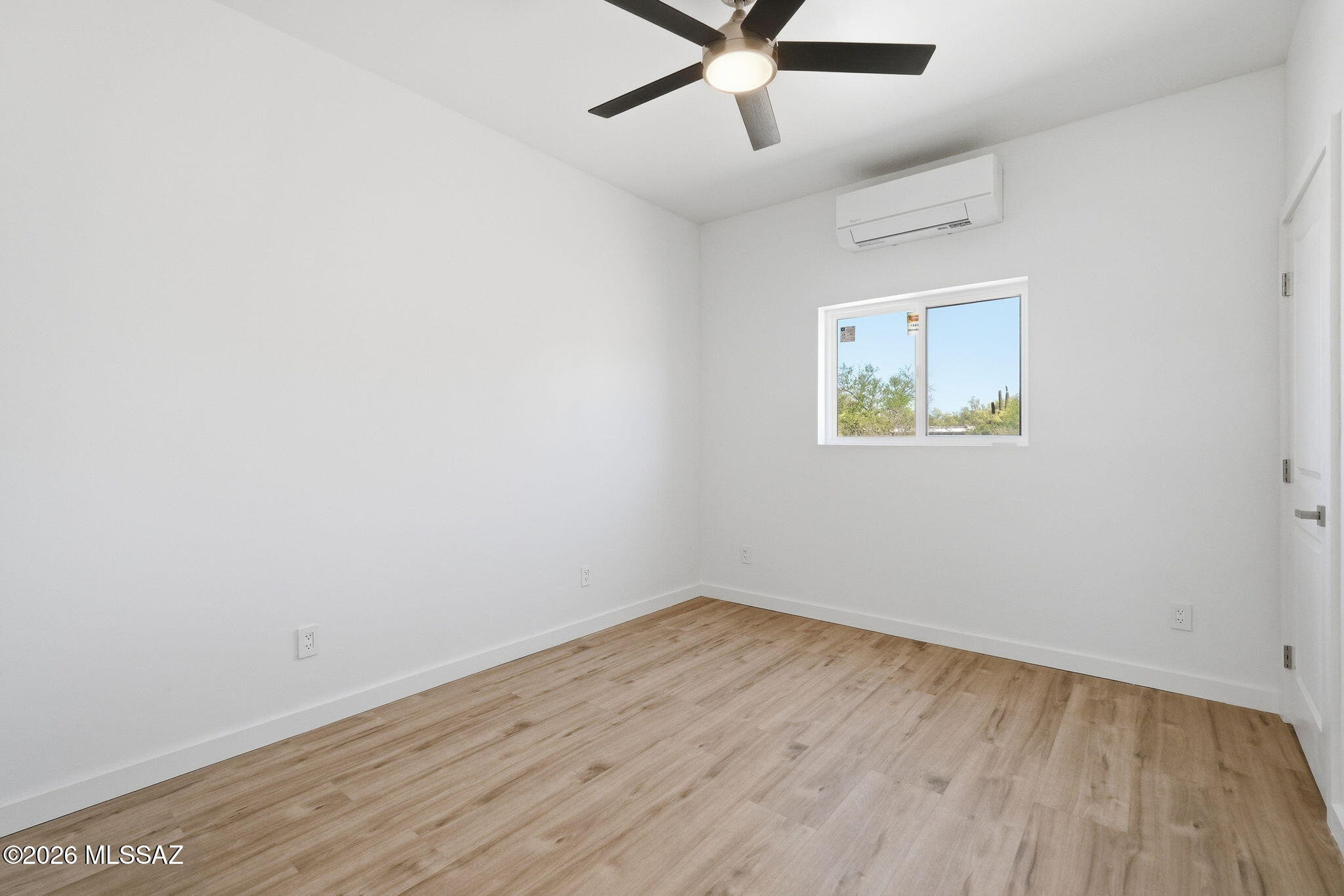 950 West Ina Road Tucson, AZ 85704 - Photo 40 of 54 an empty room with wooden floor and ceiling fan