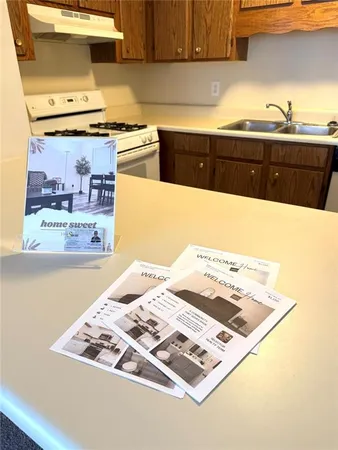 a kitchen with a stove a sink and a refrigerator
