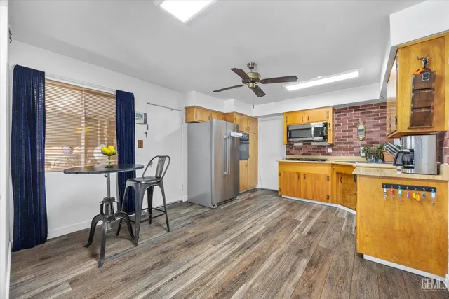 a view of a kitchen with microwave and wooden floor