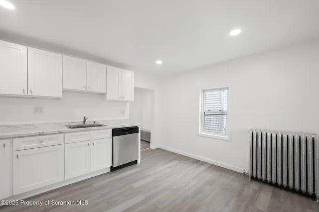 a kitchen with a refrigerator and a stove top oven
