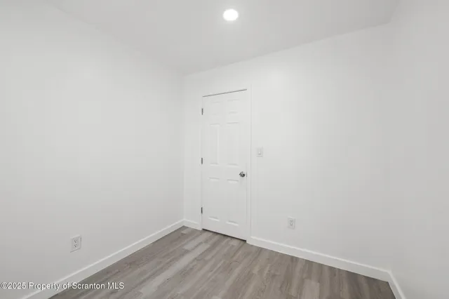 a view of room with wooden floor