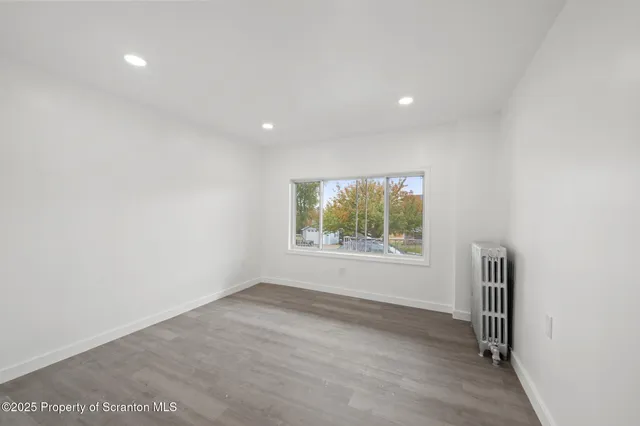 a view of wooden floor and windows in an empty room