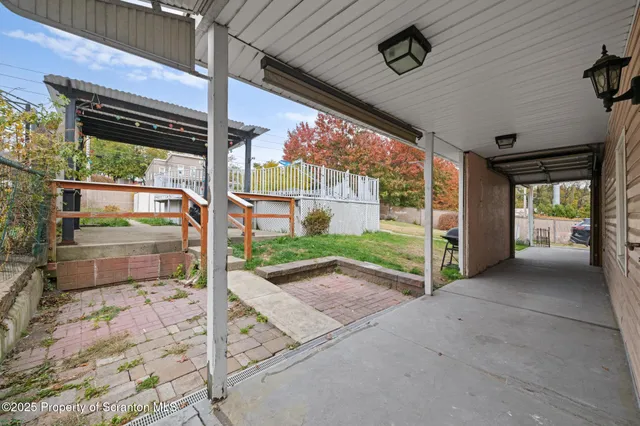 a view of a porch with furniture and a yard