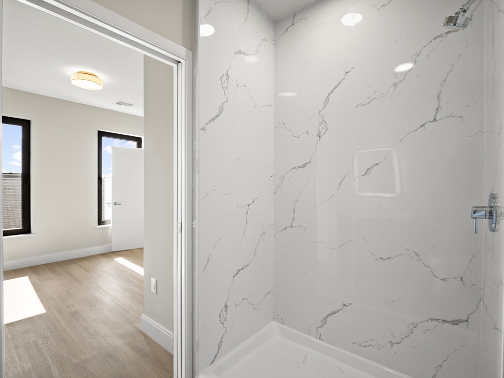 249 Corey Road, Unit 401 Boston, MA 02135 - Photo 20 of 34 a view of a bathroom with a bathtub