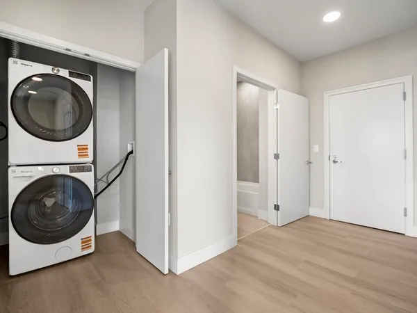 a view of a hallway with washer and dryer