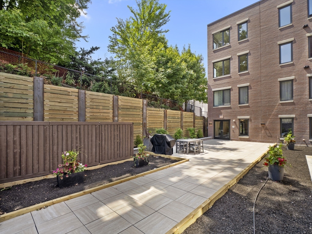 249 Corey Road, Unit 401 Boston, MA 02135 - Photo 29 of 34 a view of a lounge chair in the patio
