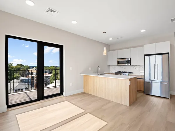 a kitchen with stainless steel appliances granite countertop a stove top oven a refrigerator a sink and a dishwasher with wooden floor