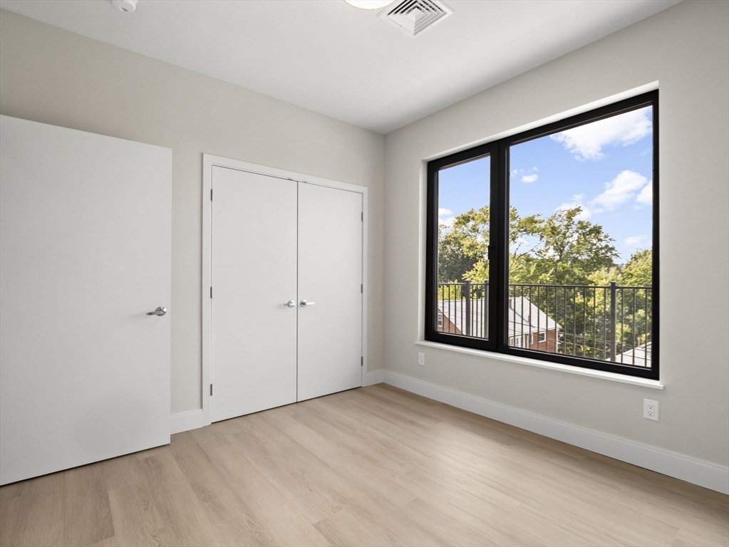 249 Corey Road, Unit 401 Boston, MA 02135 - Photo 10 of 34 a view of an empty room with a window