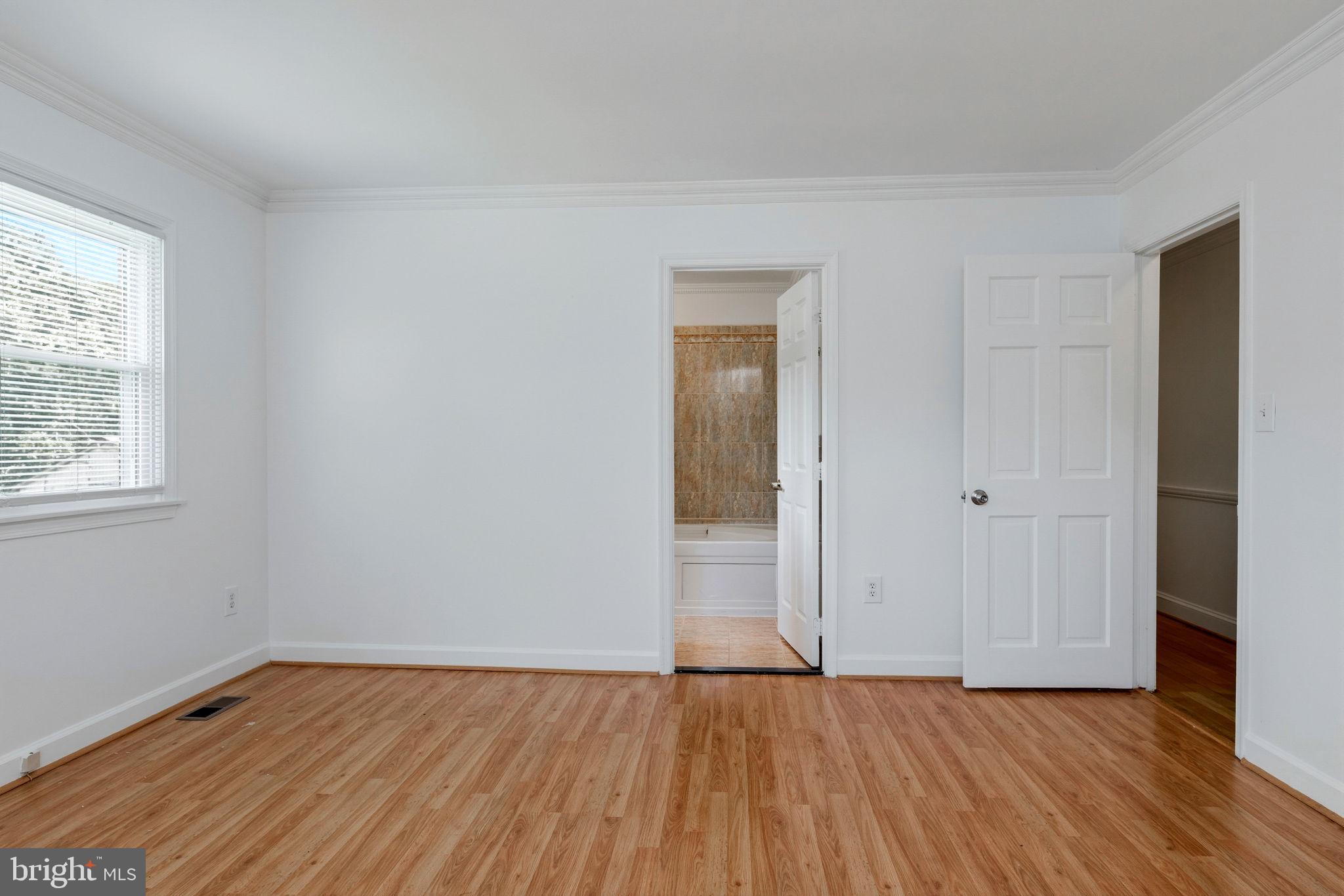 11325 Bacon Race Road Woodbridge, VA 22192 - Photo 29 of 54 an empty room with wooden floor and windows