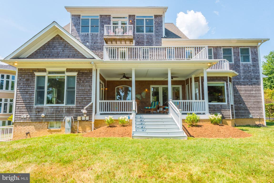 1411 Sharps Point Road Annapolis, MD 21409 - Photo 2 of 6 a view of a house with a swimming pool and a porch with furniture
