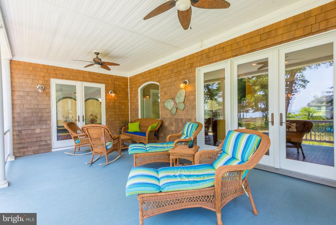 1411 Sharps Point Road Annapolis, MD 21409 - Photo 4 of 6 a living room with patio furniture and a chandelier