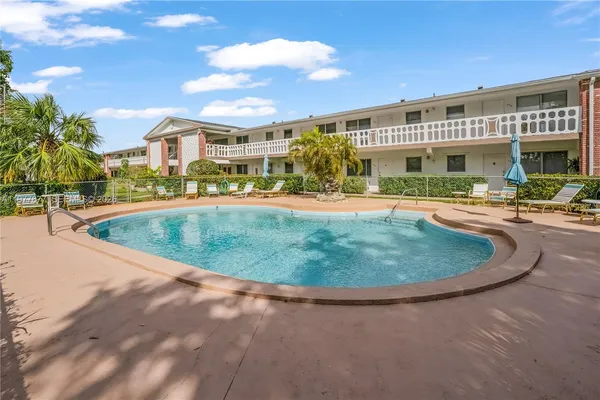 a view of a white building with a swimming pool