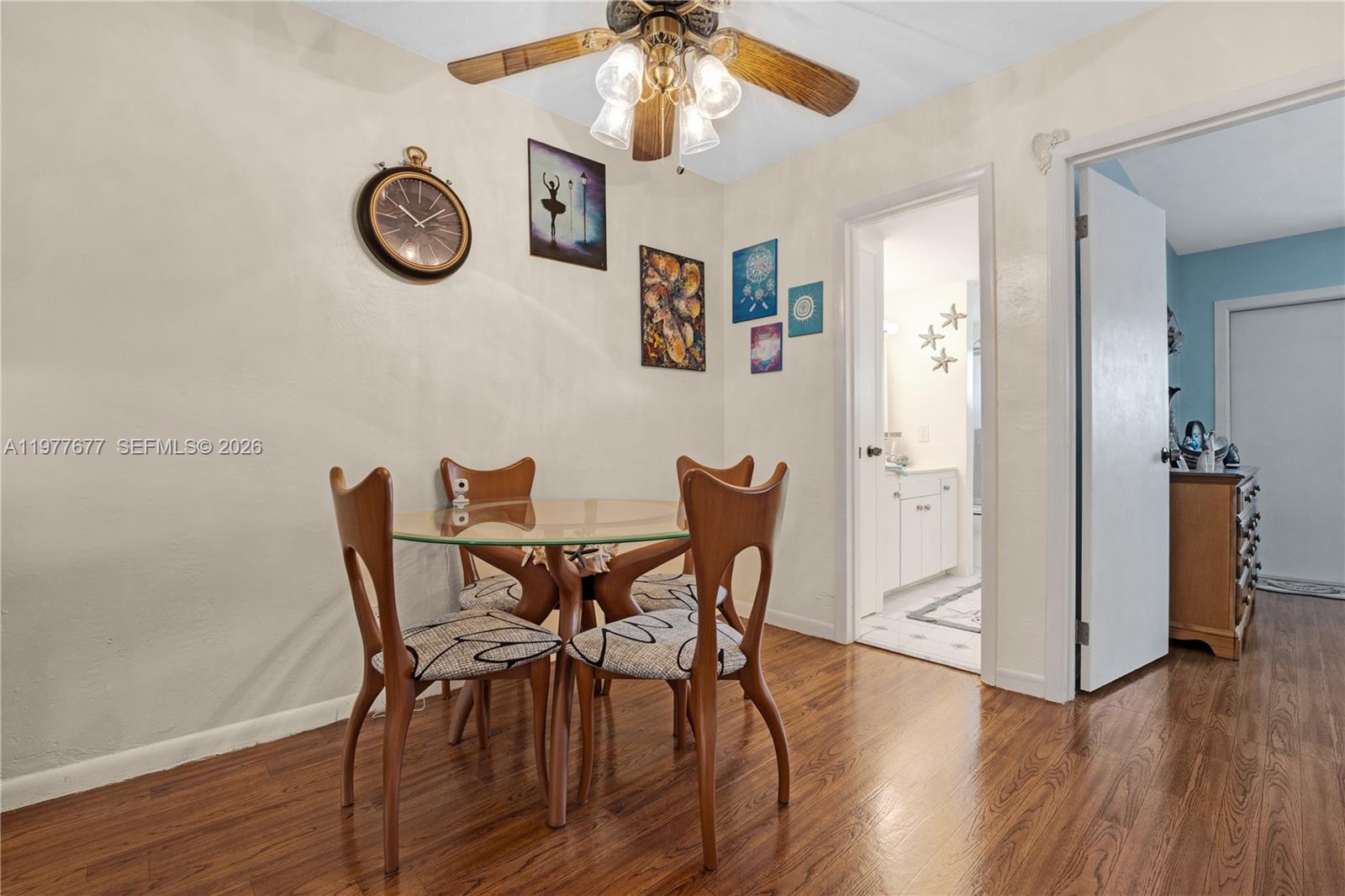 3701 Tyler Street, Unit 211 Hollywood, FL 33021 - Photo 13 of 26 a view of a dining room with furniture and wooden floor