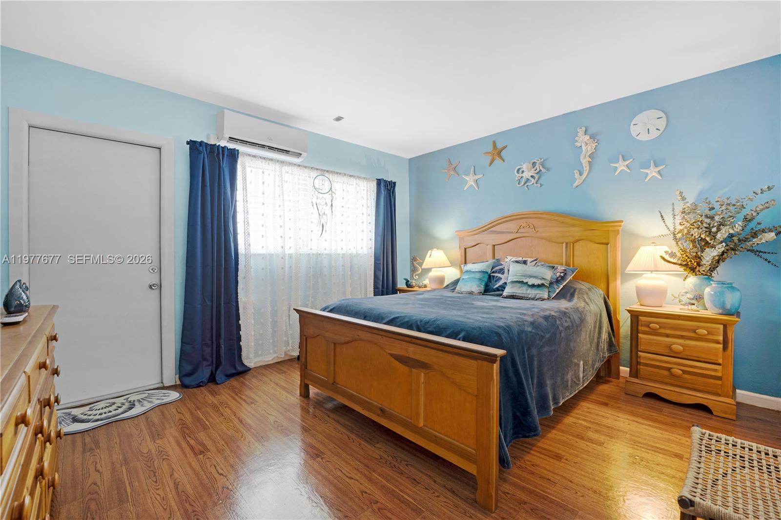 3701 Tyler Street, Unit 211 Hollywood, FL 33021 - Photo 14 of 26 a bedroom with a bed and a window