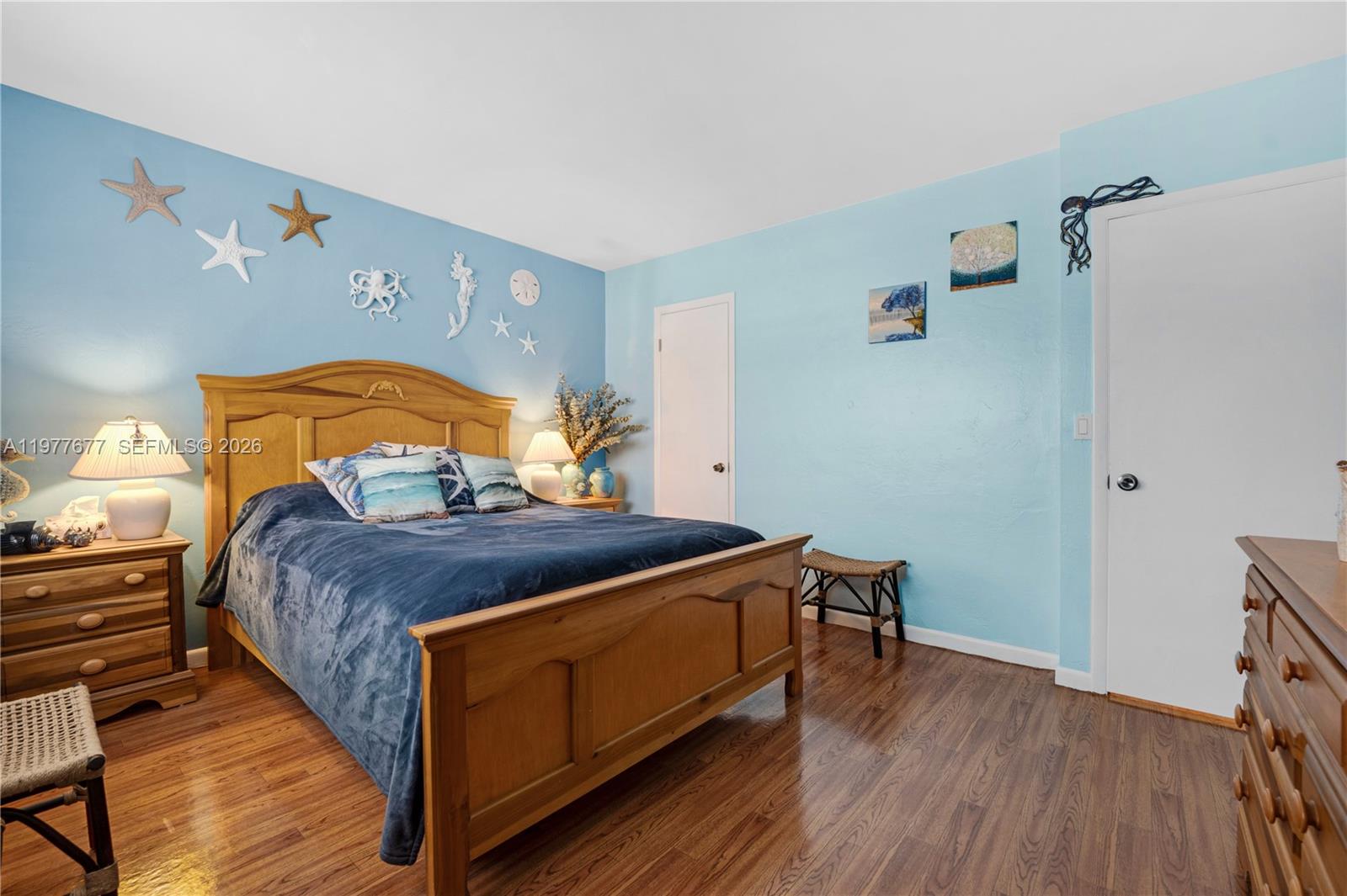 3701 Tyler Street, Unit 211 Hollywood, FL 33021 - Photo 15 of 26 a bed sitting in a bedroom next to a window