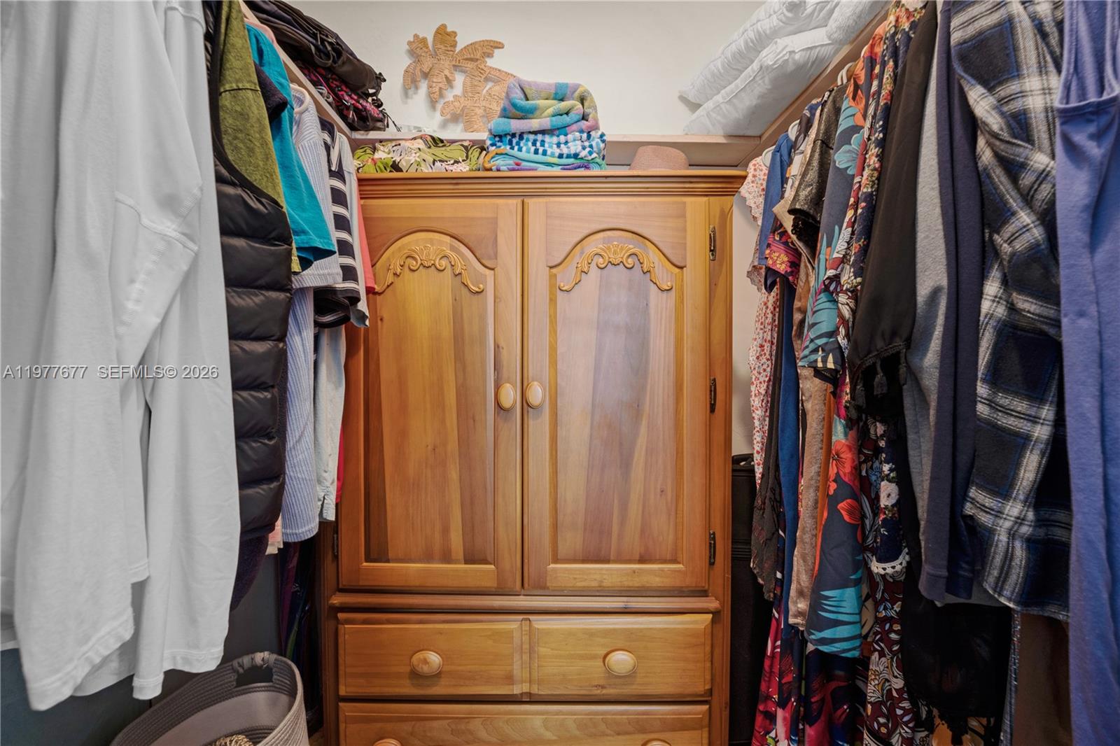 3701 Tyler Street, Unit 211 Hollywood, FL 33021 - Photo 16 of 26 a view of walk in closet with clothes