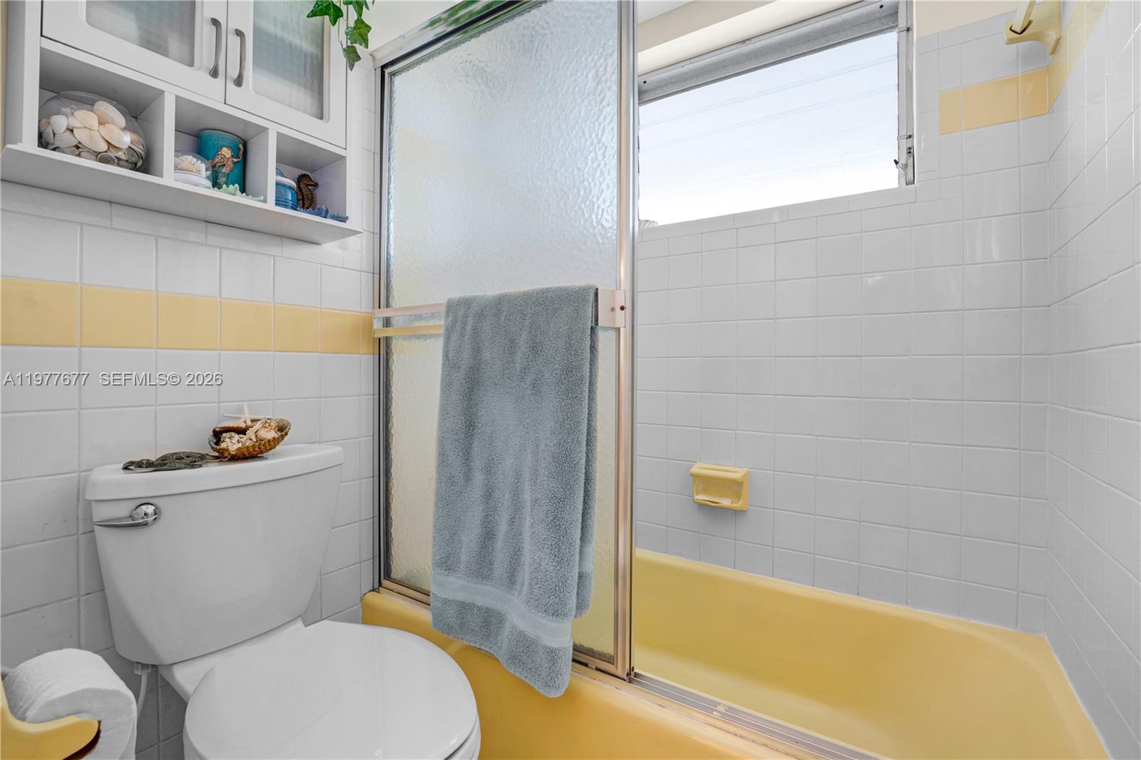 3701 Tyler Street, Unit 211 Hollywood, FL 33021 - Photo 18 of 26 a bathroom with a toilet and a bathtub