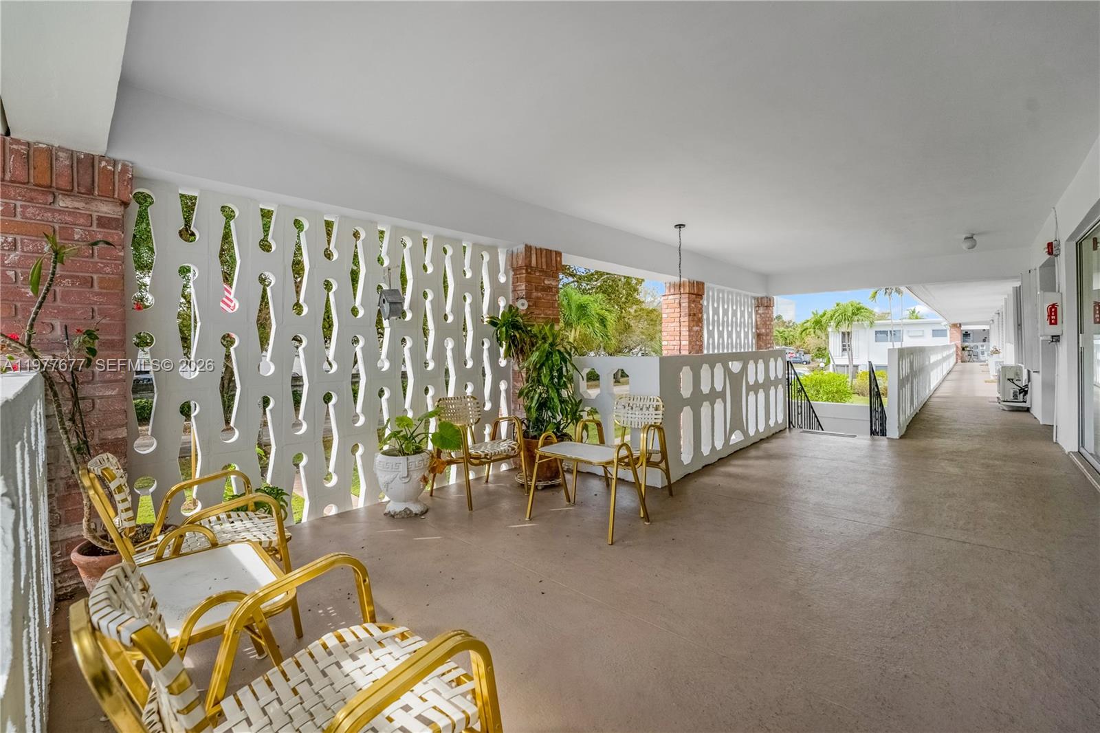 3701 Tyler Street, Unit 211 Hollywood, FL 33021 - Photo 19 of 26 a view of a livingroom with furniture white walls and wooden floor