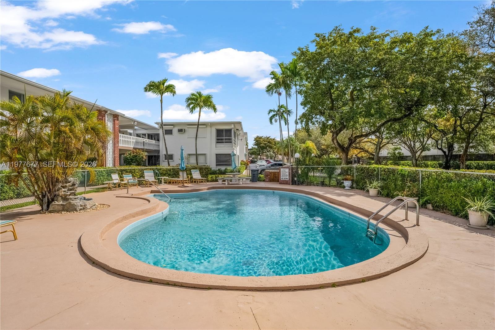 3701 Tyler Street, Unit 211 Hollywood, FL 33021 - Photo 20 of 26 a view of a swimming pool with a yard