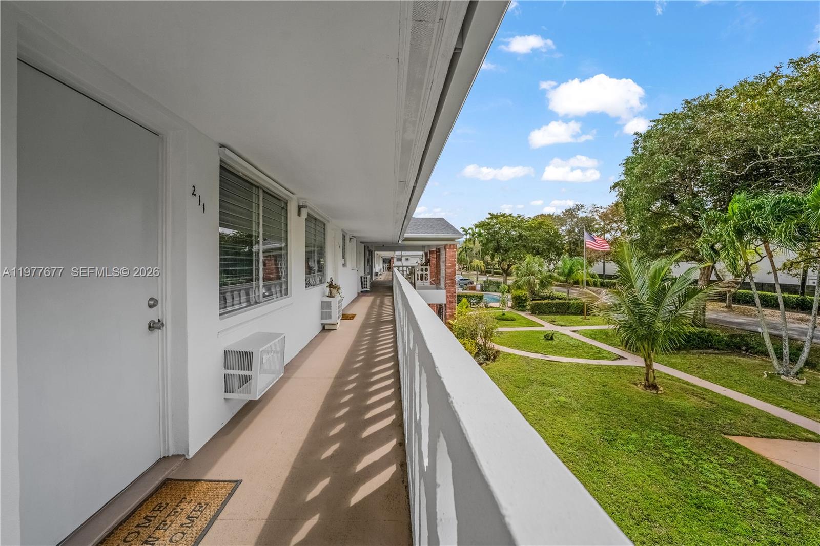 3701 Tyler Street, Unit 211 Hollywood, FL 33021 - Photo 5 of 26 a view of balcony with two chairs and a table