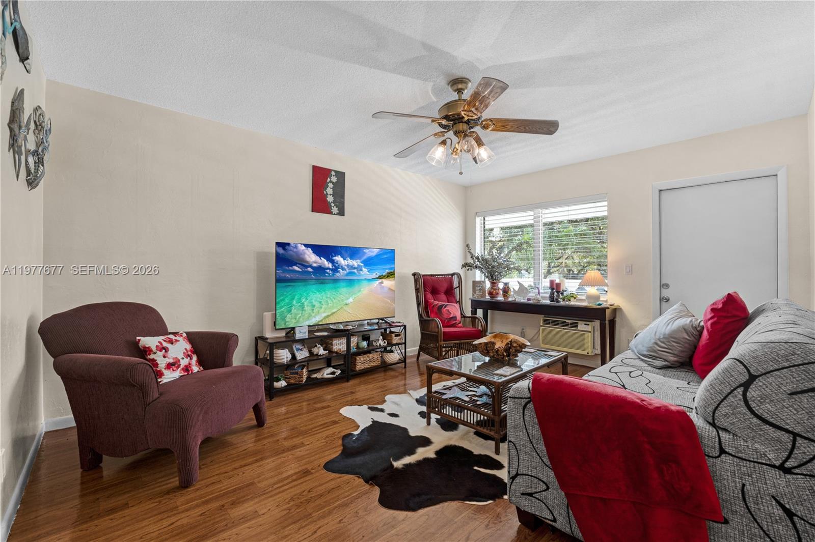 3701 Tyler Street, Unit 211 Hollywood, FL 33021 - Photo 6 of 26 a living room with furniture fireplace and window