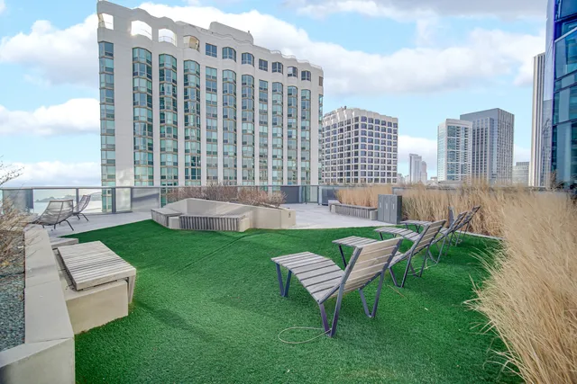 a view of a chairs and table in the backyard