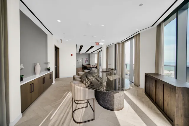 a living room with furniture a flat screen tv and a large window