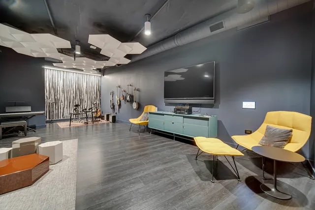 a view of a livingroom with furniture and a flat screen tv