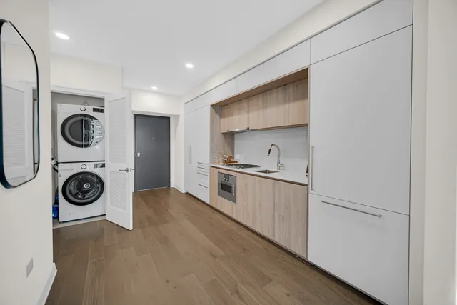a kitchen with a stove top oven sink and cabinets