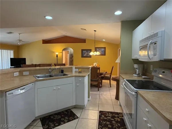 a kitchen with stainless steel appliances a sink stove and cabinets