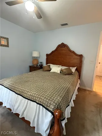 a bedroom with a bed and a night stand