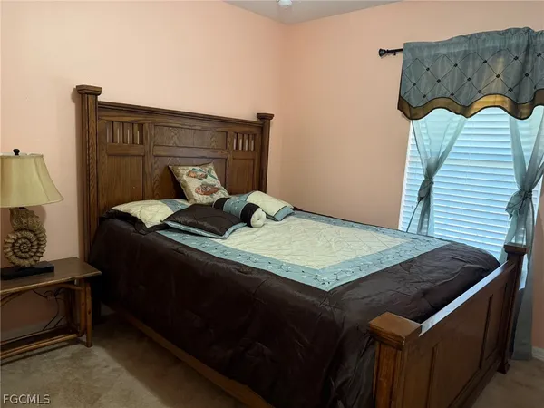 a bedroom with a bed and dresser