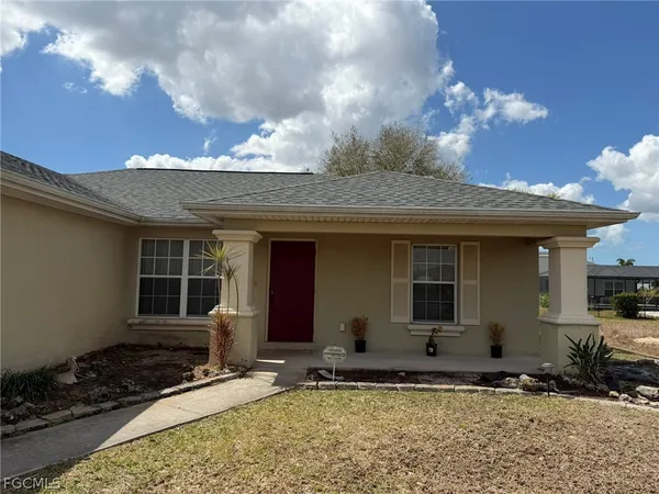 a view of a house with a yard and sitting space