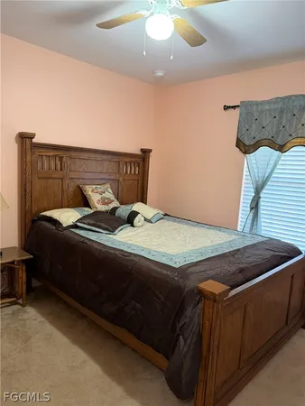 a bedroom with a bed and lamp