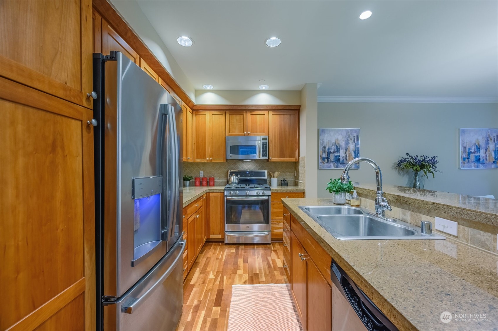 505 5th Avenue South, Unit 203 Edmonds, WA 98020 - Photo 2 of 24 a kitchen with stainless steel appliances granite countertop a sink stove and refrigerator