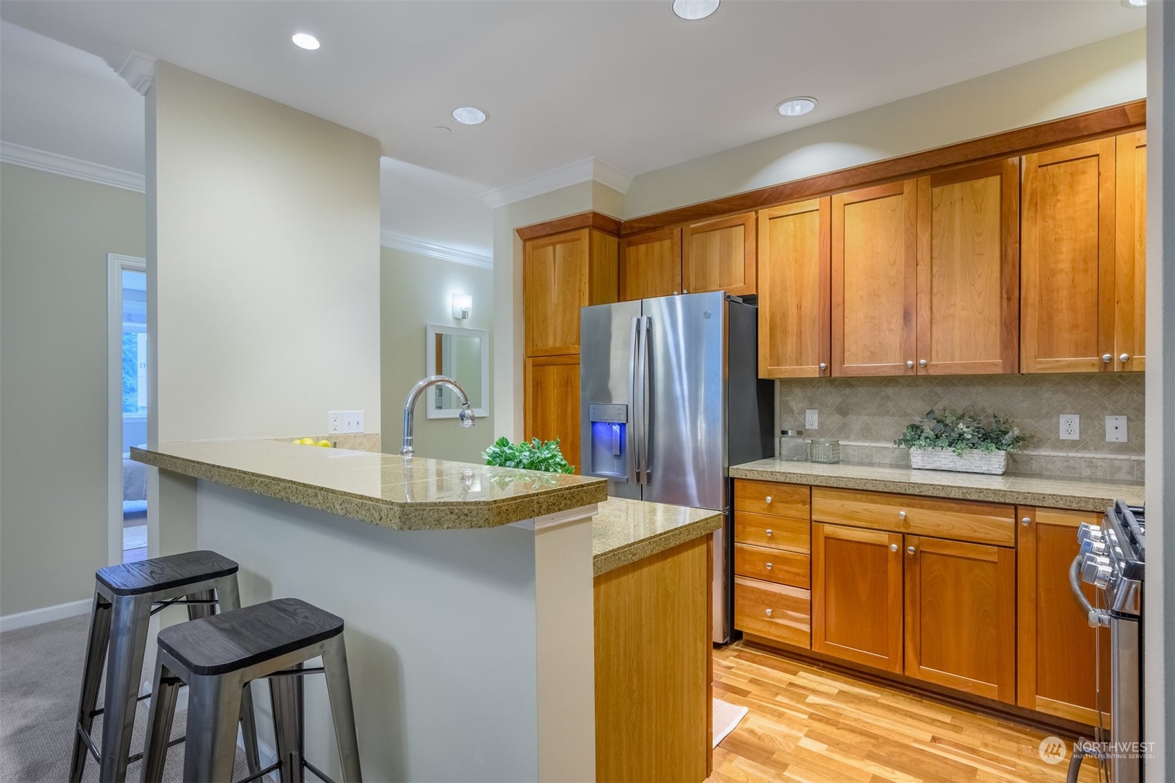 505 5th Avenue South, Unit 203 Edmonds, WA 98020 - Photo 5 of 24 a kitchen with refrigerator and cabinets
