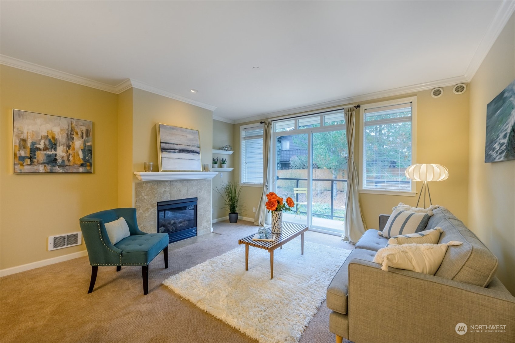 505 5th Avenue South, Unit 203 Edmonds, WA 98020 - Photo 9 of 24 a living room with furniture a fireplace and a floor to ceiling window