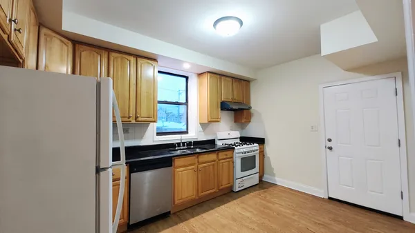 a kitchen with stainless steel appliances a stove and a refrigerator